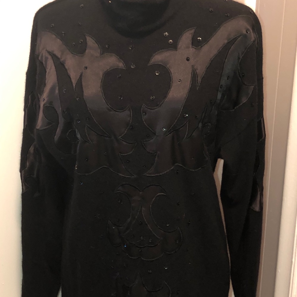 sweater with a design with black shiny beads.